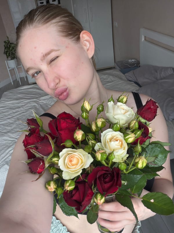 Woman photographed with rose bouquet in Rossiyskiy bedroom