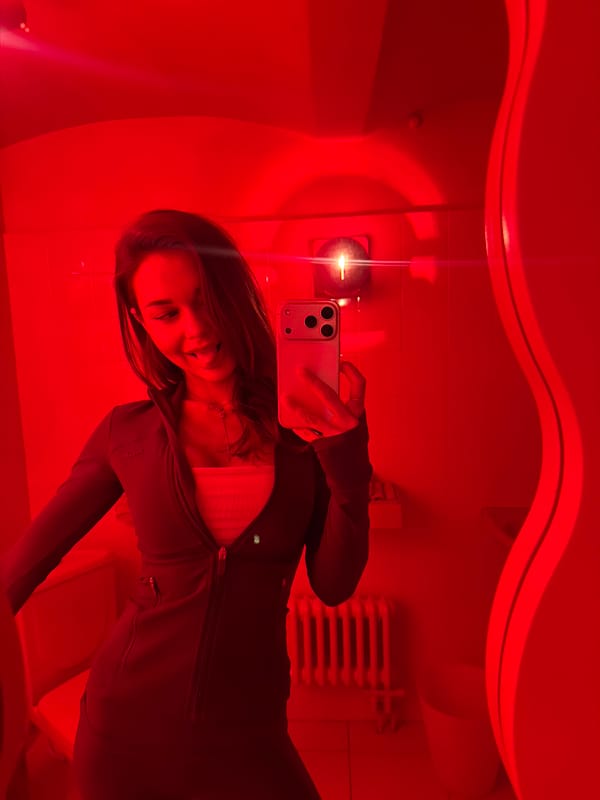 Woman photographs herself and Moscow architecture during evening session