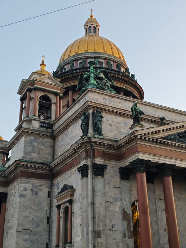 Evening tourist activity captured around Saint Isaac's Cathedral, Saint Petersburg