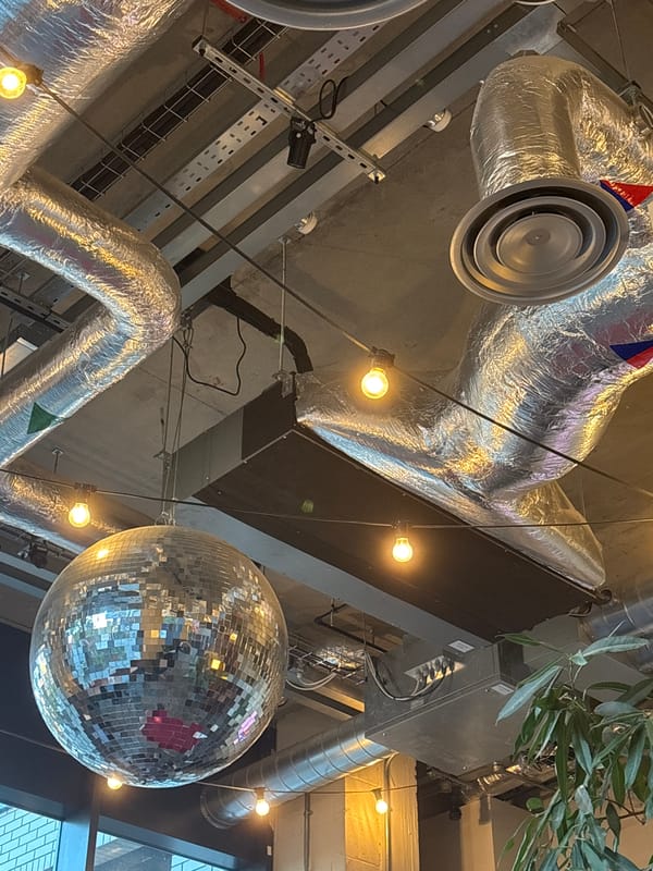 Metal shoe sculpture observed in London urban setting