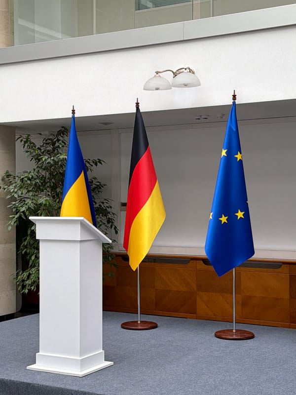 Formal event setup with podium, flags observed in Kyiv