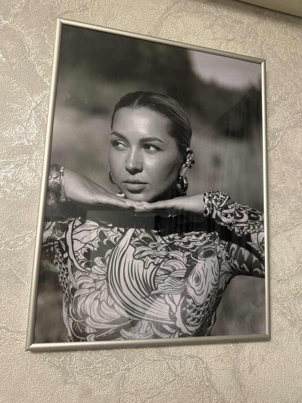 Framed black and white portrait photograph on a textured wall