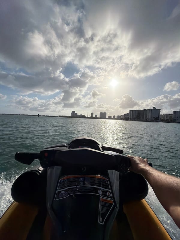 Personal watercraft rider photographs Bay Harbor Islands skyline