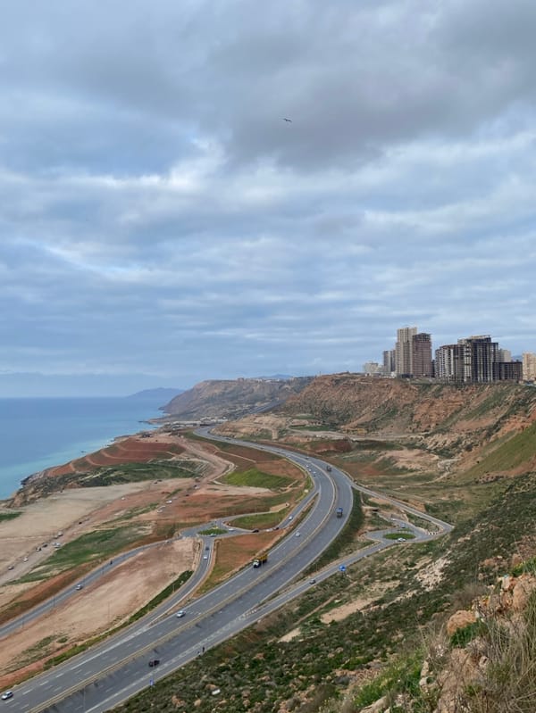 Overcast coastal panorama captured along Oran's Mediterranean highway
