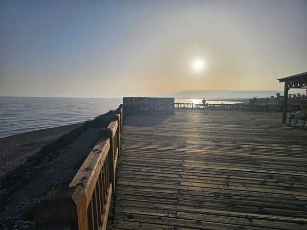 Golden hour sunrise captured along Almeria coastal boardwalk