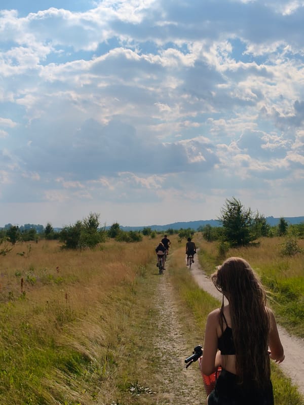 Group bike ride along rural dirt path near Ustyvytsya, Ukraine
