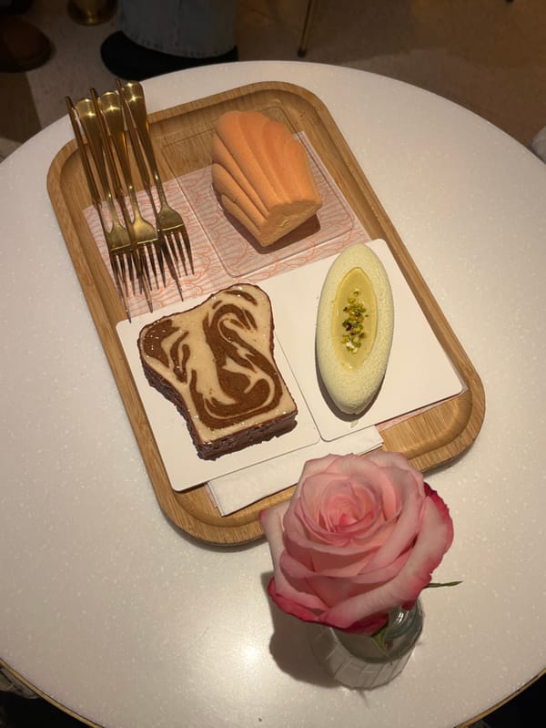 Woman enjoys tea and pastries at Paris café
