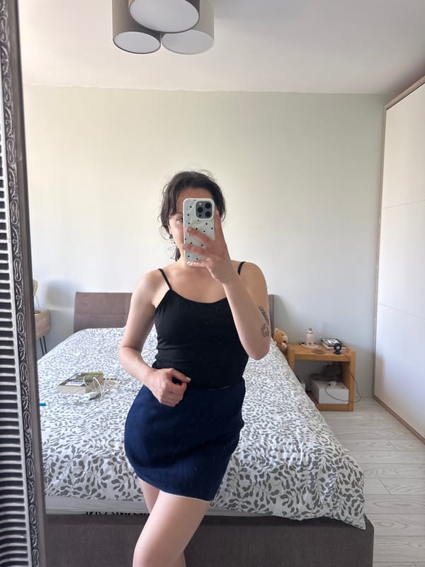 Woman takes mirror selfie in bedroom in Burgas, Bulgaria
