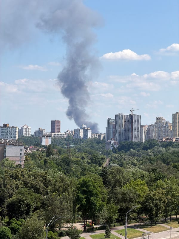 Dark smoke rises over Kyiv skyline on a clear morning