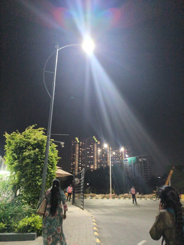 Evening pedestrian activity observed on illuminated Bengaluru streets