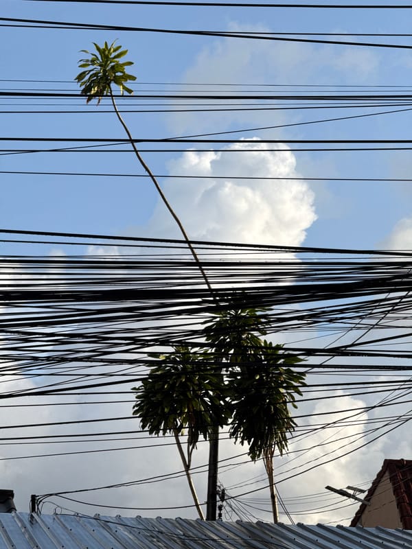 Double rainbow over rain-soaked streets in Wichit, Thailand