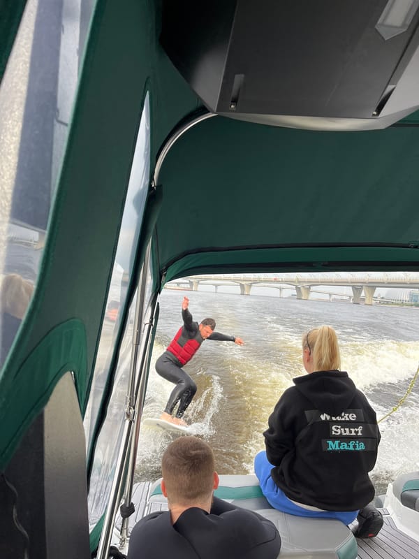 Wake surfing the Neva River with a bridge backdrop