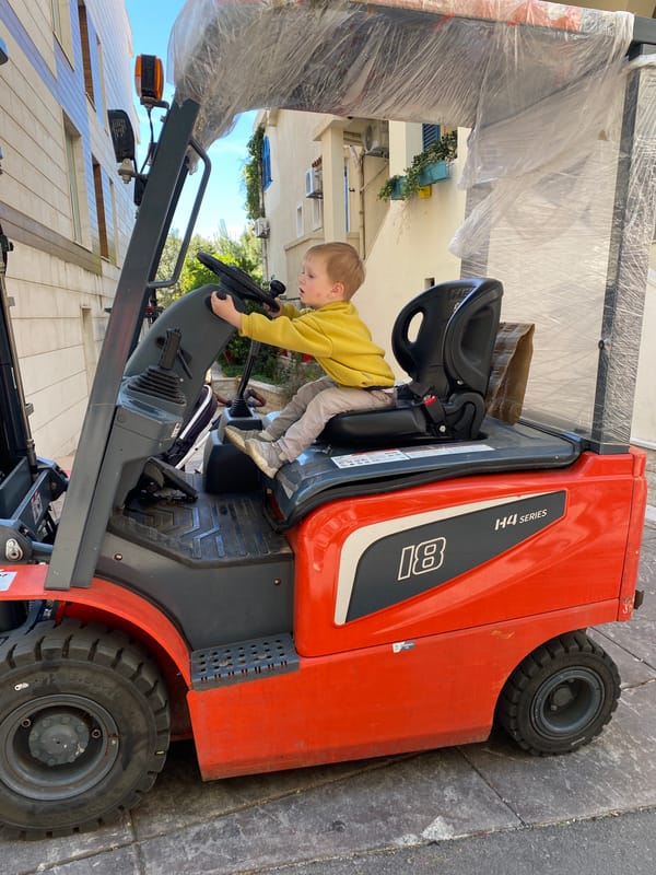 Child plays on parked forklift in Montenegro coastal town