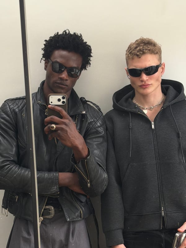 Two men captured in mirror reflection in London