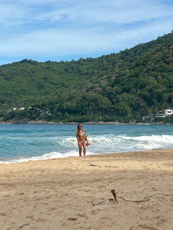 Woman enjoys late night beach moment in Rawai, Thailand