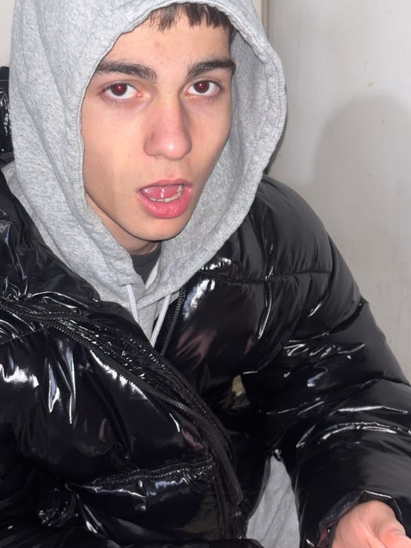 Young person vaping, using phone in Lehchevo street gathering