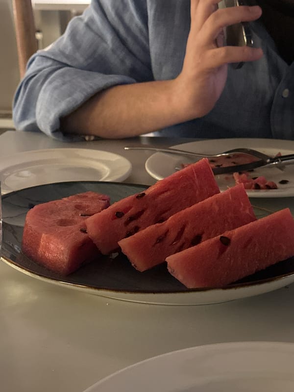 Evening moments captured in Yerevan: watermelon serving and cinema facade