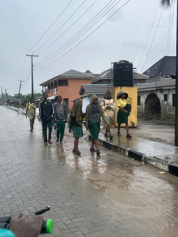 Students navigate flooded Badagry streets after school in the rain