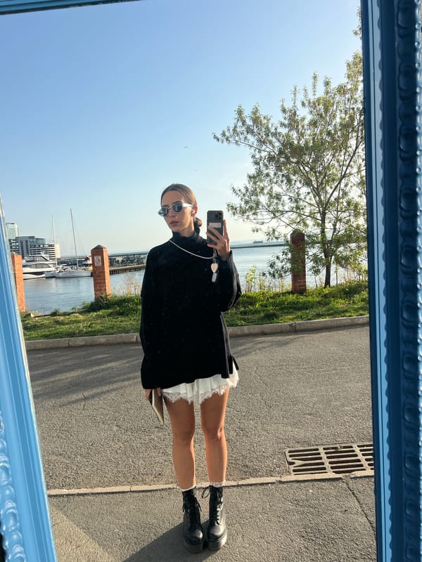 Woman takes mirror selfie overlooking Vladivostok harbor