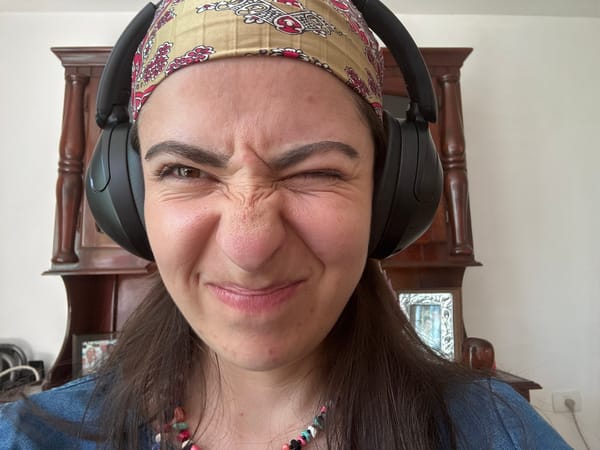 Woman in headphones squints indoors in Puebla home