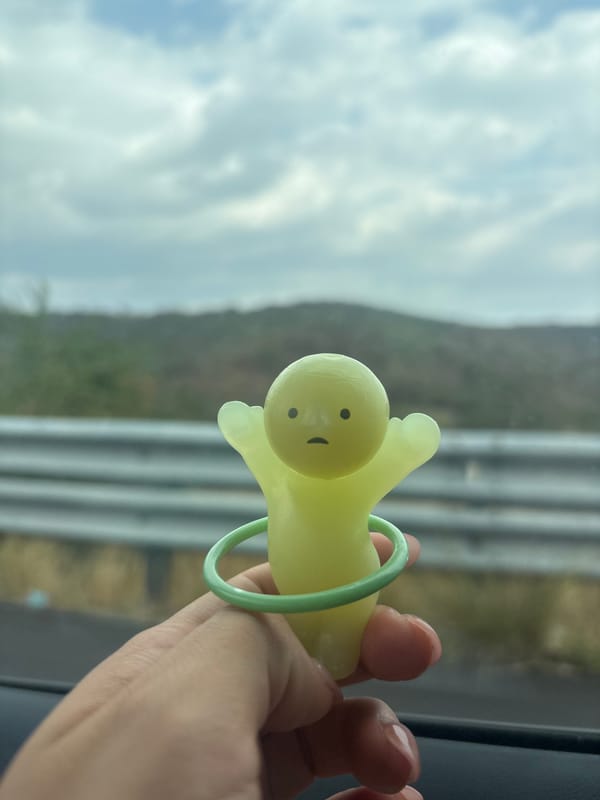 Person holds yellow cartoon toy in Mexican town window