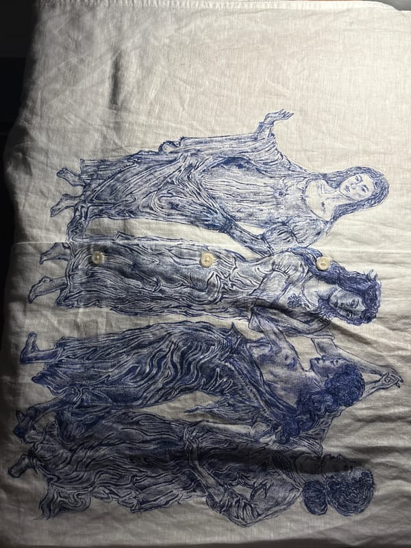 Blue-ink female figures artwork spotted on fabric garment Manchester