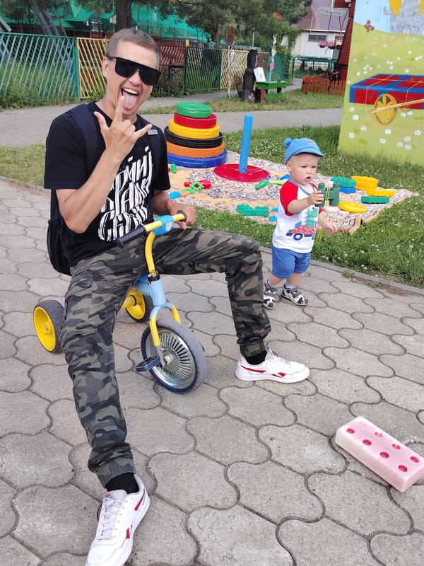 Summer day out at a Chaikovsky fairground, river in the background