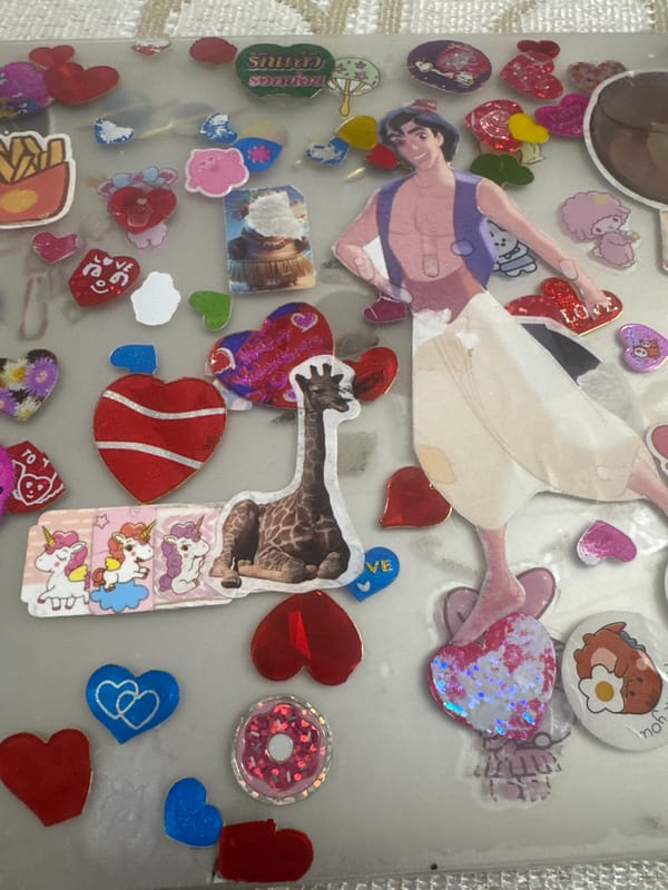 Heart stickers layered across a clear notebook surface