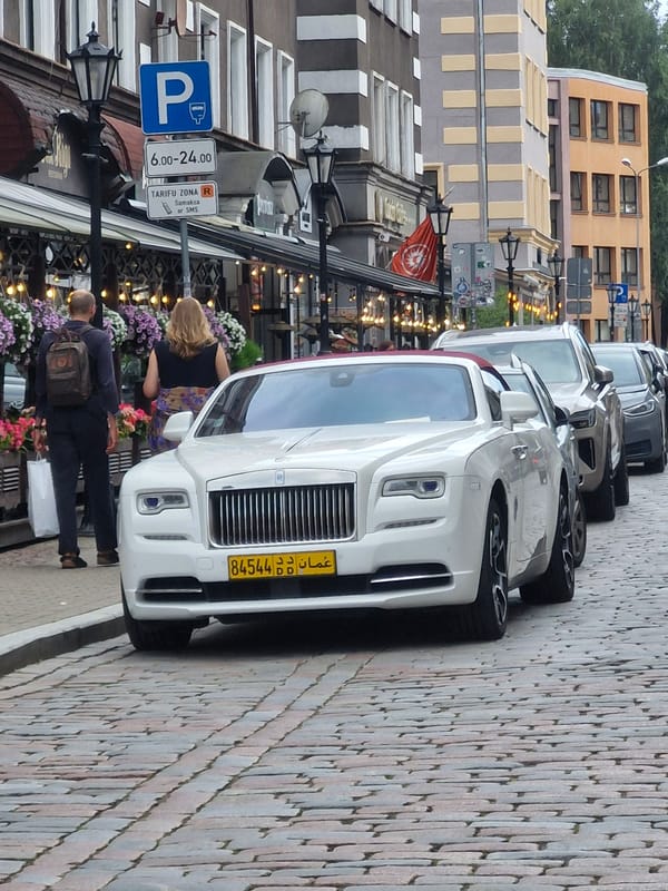 Rolls-Royce and rhino sculpture on Riga's cobblestone streets
