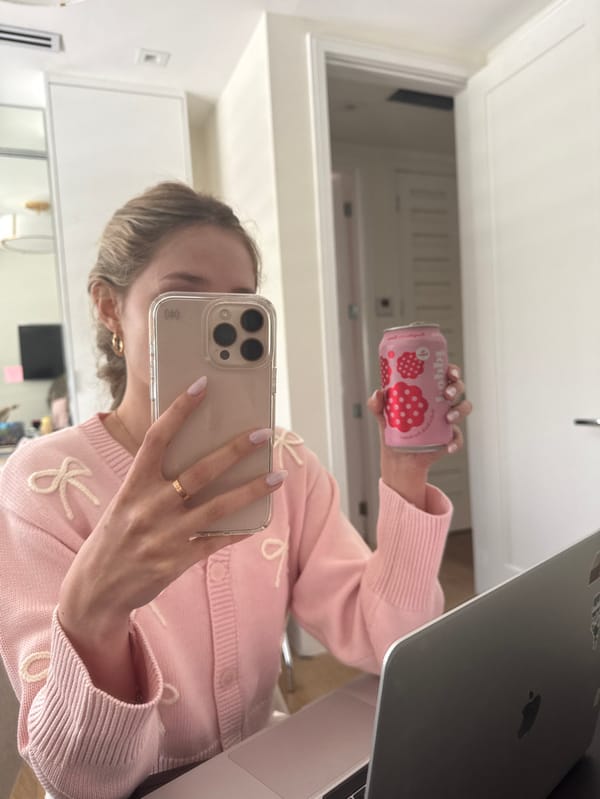 Woman takes mirror selfie with smartphone in Coral Gables
