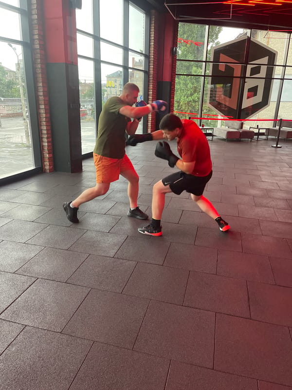 Sparring session in a boxing gym, gloves on and going.