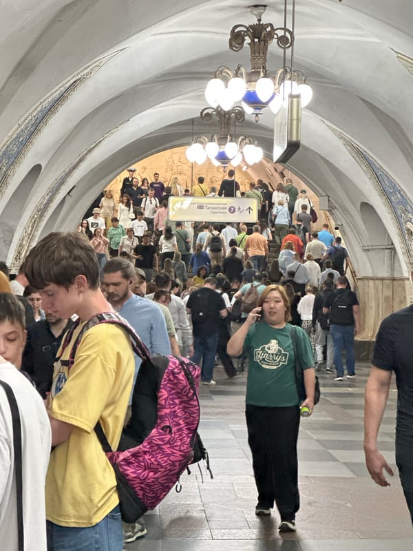 Moscow residents navigate metro station and street art corridor