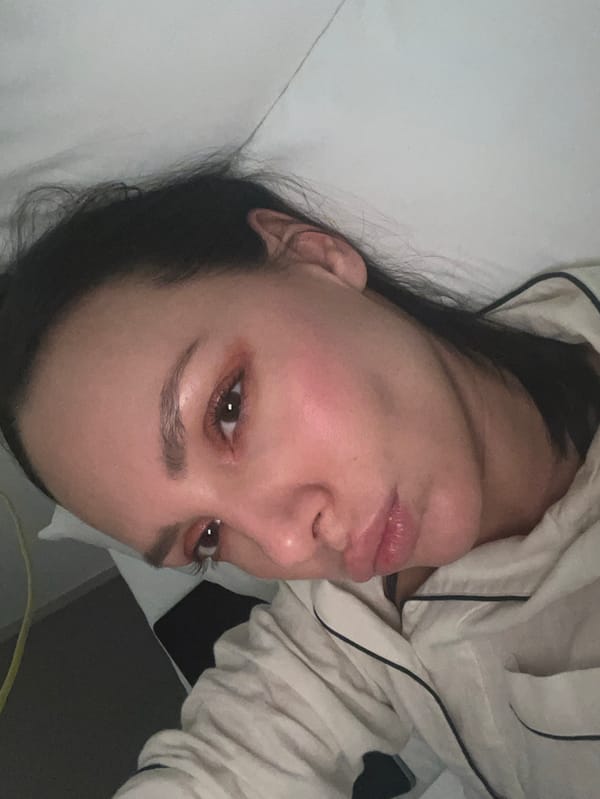 Woman photographed resting on white surface in Shibuya interior