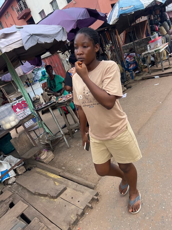 Midday street commerce and everyday movement in Nkpor, Nigeria