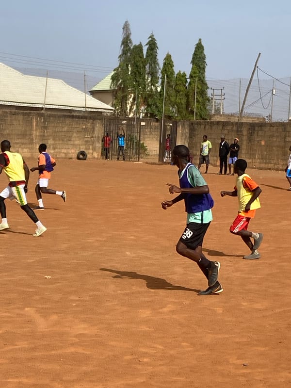 Person displays colorful Adidas Predator sneaker in Jos, Nigeria