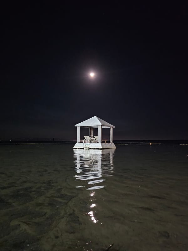 Full moon night at a floating gazebo off Denpasar's waterfront