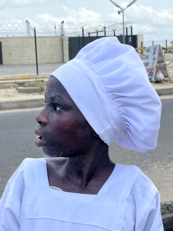 Chefs in white uniforms gathered on Ado street