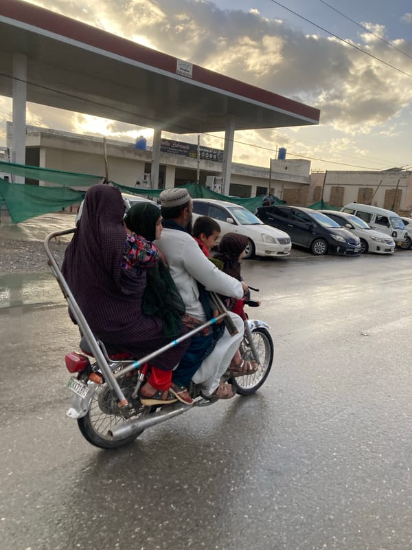 Family motorcycle ride observed on wet Quetta streets