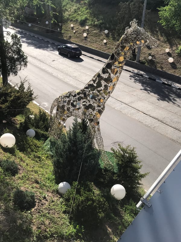 Zoo visit in Kharkiv with giraffe sculpture and bridge views
