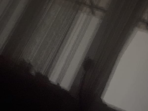 Low-angle indoor scene shows vertical patterns in darkened space