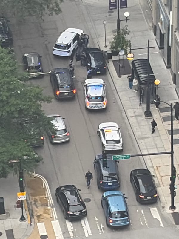 Chicago streets and skyline on a hazy day, police presence noted