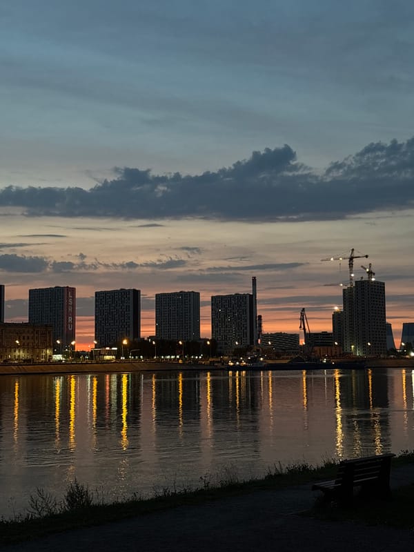 Dusk settles over a Neva River waterfront bench