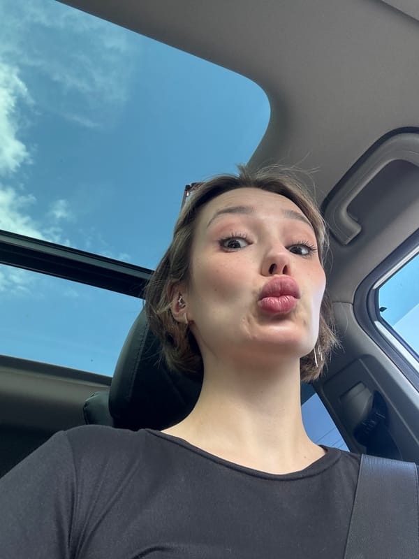 Woman takes selfies in parked car with sunroof