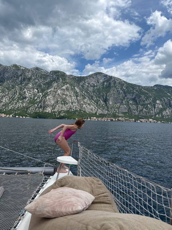 Woman relaxes on sailboat bow in Montenegro waters