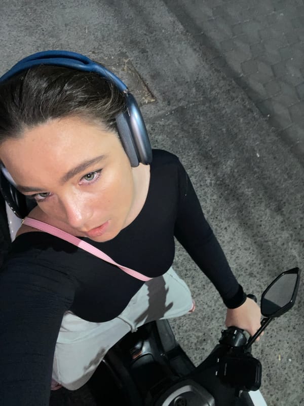 Scooter pause and selfie at dusk, palm trees on the horizon