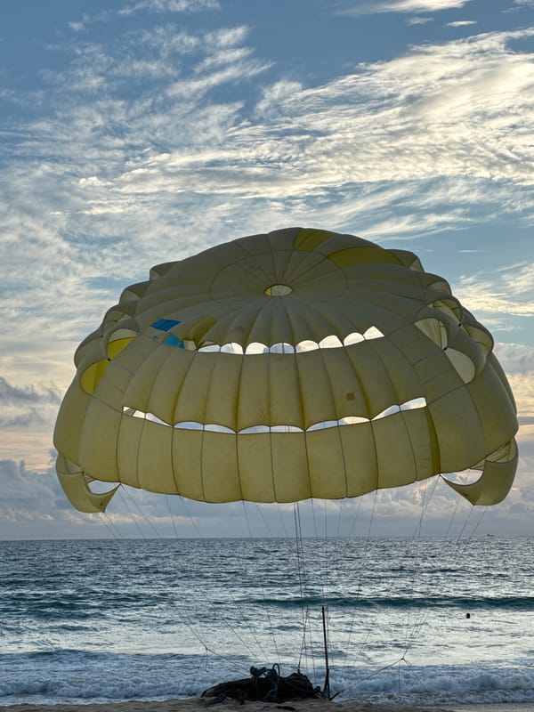 Karon Beach afternoon: parasails, street stalls, and golden-hour light