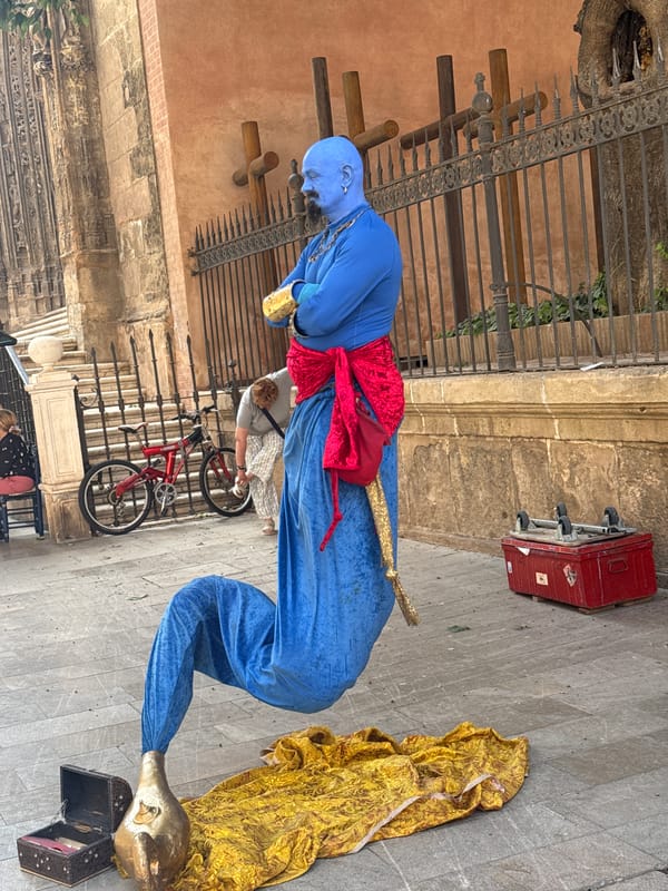 Street performers and Málaga Cathedral on a busy morning