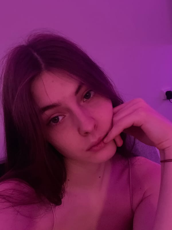 Woman takes late-night selfies in purple-lit Saint Petersburg apartment