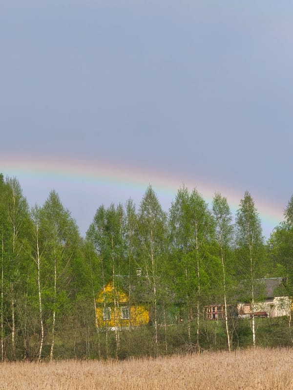 Rainbow appears over rural Belarus countryside