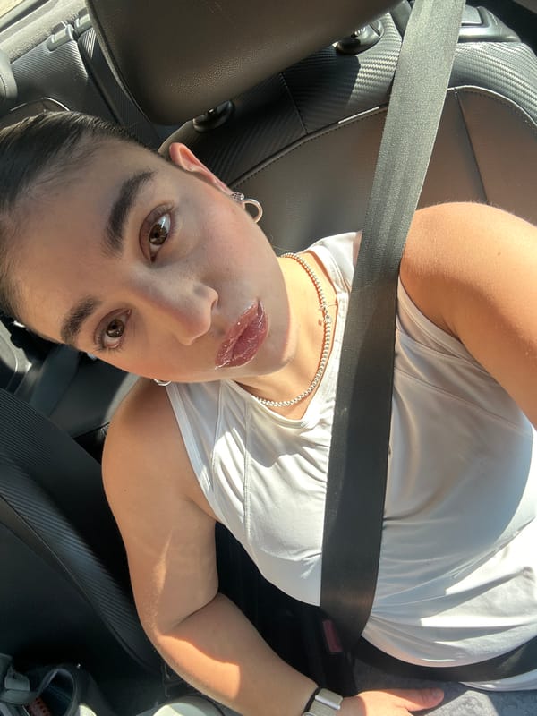 Two people photographed in car interior in Puebla